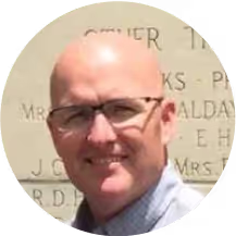 A bald man with a white shirt smiling. - Brisk Teaching Images